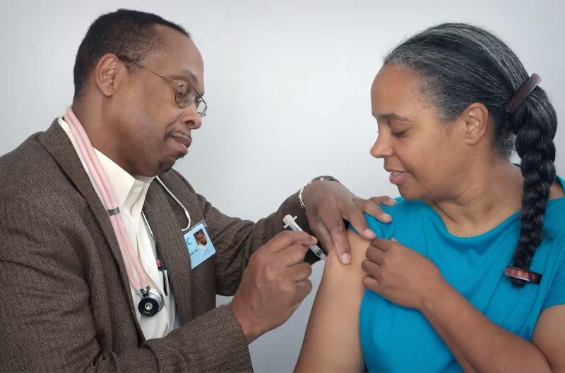 a doctor injecting a cure into a woman's arm