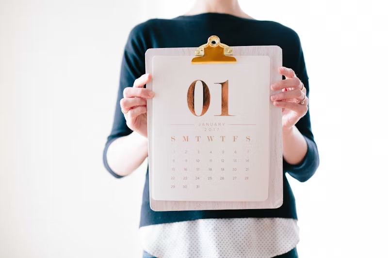 a person holding up a calendar