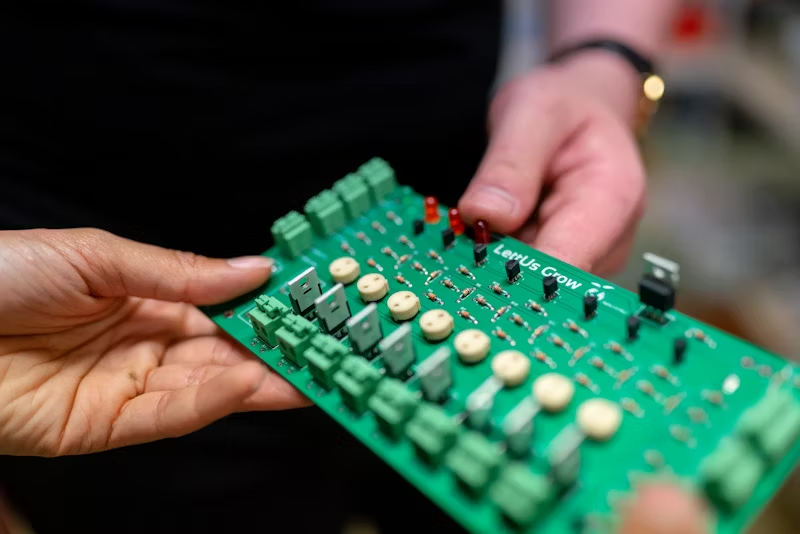a person holding a circuit board