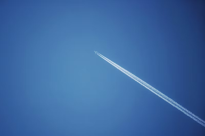 a plane flying leaving condensation trails