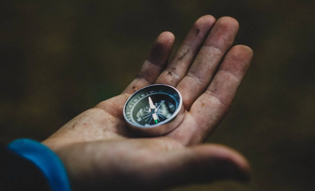 a compass in someone's hand