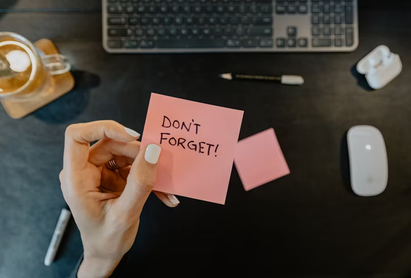 a sticky note that reads "Don't Forget!"