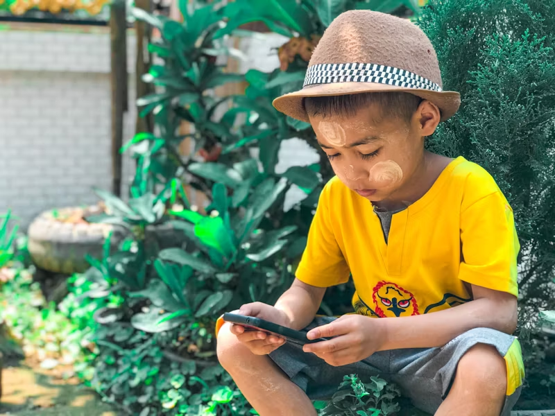 a kid looking at a phone