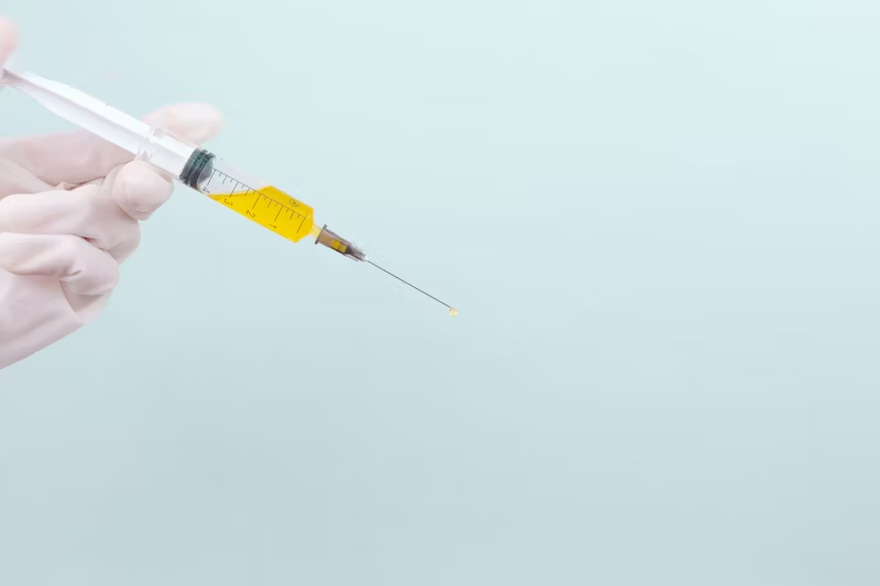 a yellow vaccine in a needle