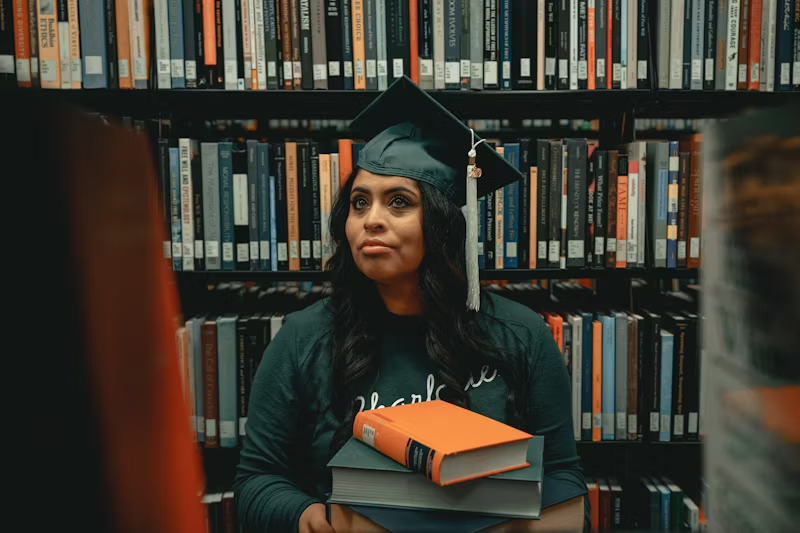a graduate finding books in a library