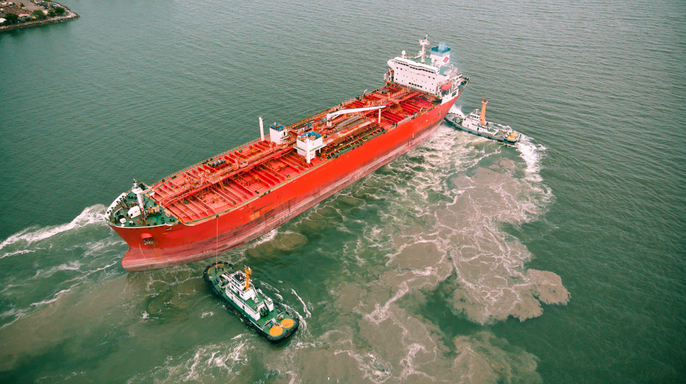 Aerial view of Dorn Tug boats pull the newly refurbished tanker out of the shipyard.
