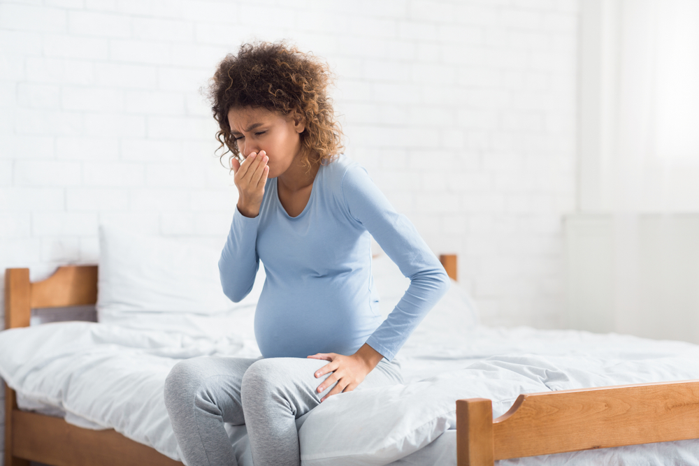 Morning sickness. African-american expectant woman feeling nauseous, covering mouth