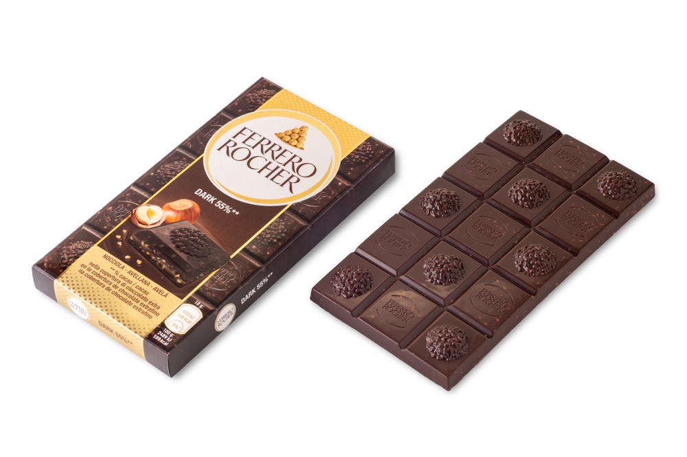 Alba, Italy - February 25, 2023: Package of Ferrero Rocher Dark bar with chocolate bar and hazelnuts isolated on white, clipping path included