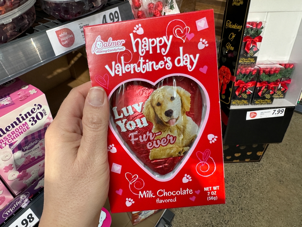 Fairfax, Virginia - February 3, 2024: Hand holds up a Palmer milk chocolate heart for Valentine's Day