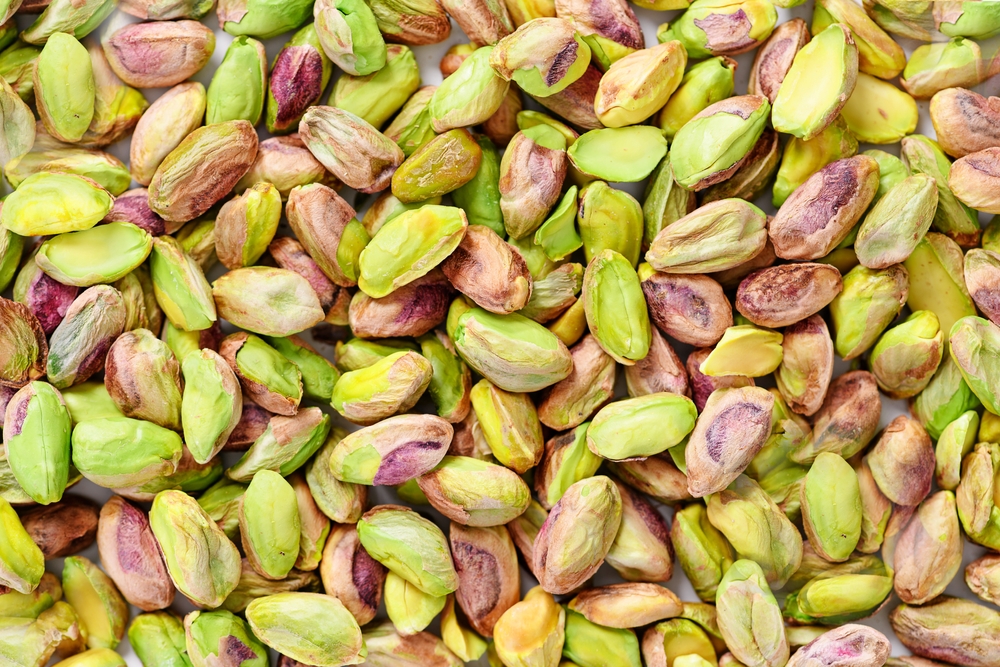 Peeled pistachio nuts background texture
