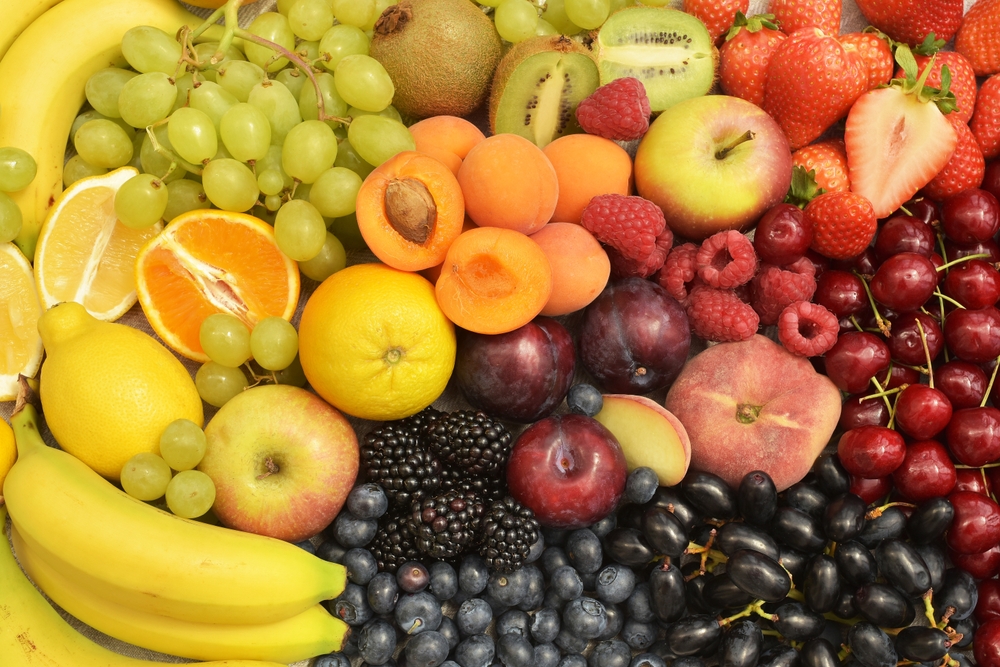 Fresh summer different berries, fruits colourful background. Banana, grapes, cherries, lemon, orange, apricots, apple, blackberries, raspberries, blueberries, strawberries, kiwi, plum. Healthy food.
