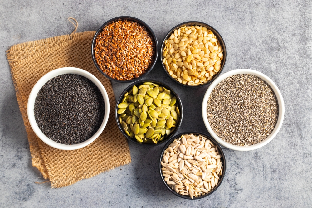 pumpkin, flex seeds, watermelon, sunflower sabja seeds, chia seeds on bowls, for good healthy mind and body, enriched minerals and vitamins.