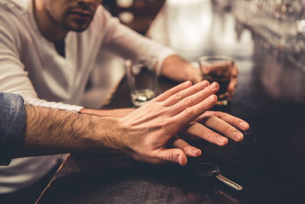 Do not drink and drive! Cropped image of drunk man talking car keys and his friend stopping him
