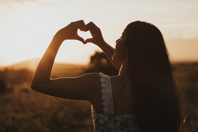 girl making heart sign