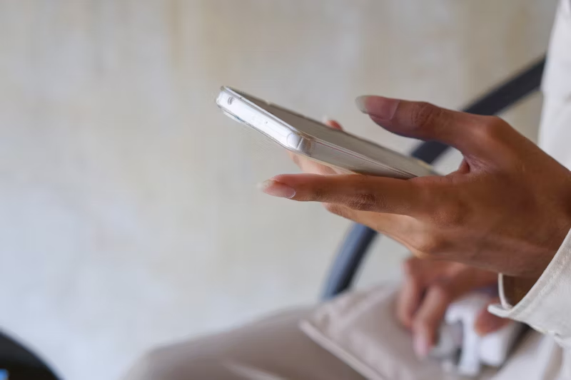 a woman's hand holding a phone