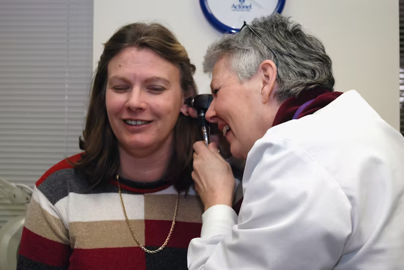 woman getting her ears checked by a doctor