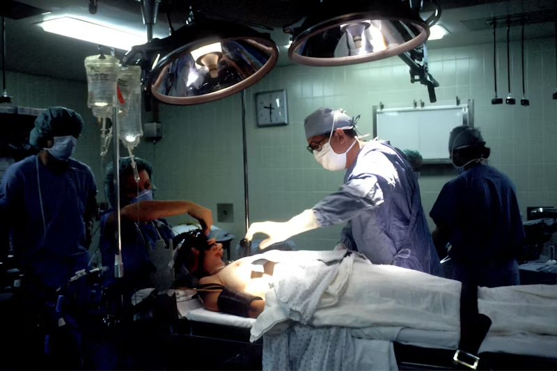 a person prepped in the surgery room with doctors around them