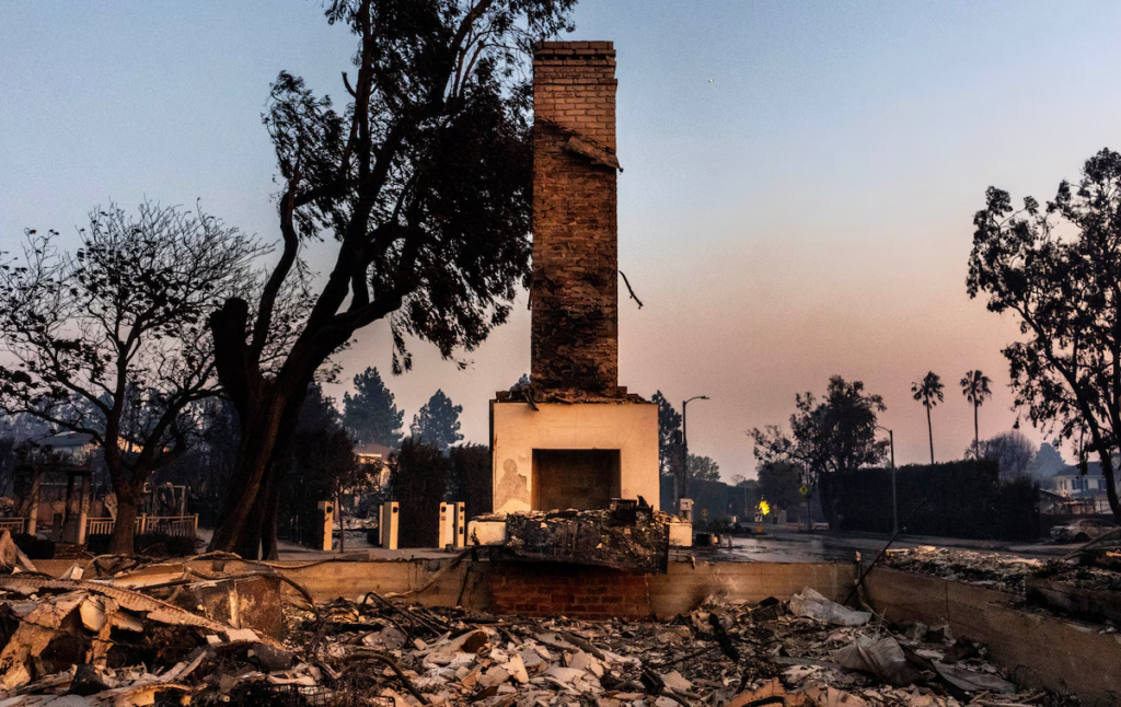 With a smoky sunset as a backdrop, homes destroyed by the Palisades Fire are seen in the Pacific Palisades neighborhood of Los Angeles on Wednesday. 