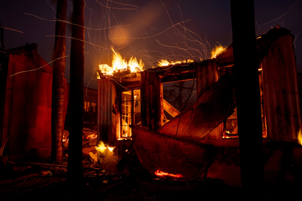 Embers fly from a burning structure during the Eaton fire in Altadena, California. 