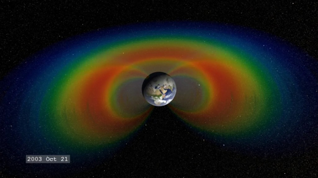 When solar material streams strikes Earth’s magnetosphere, it can become trapped and held in two donut-shaped belts around the planet called the Van Allen Belts. The belts restrain the particles to travel along Earth’s magnetic field lines, continually bouncing back and forth from pole to pole.