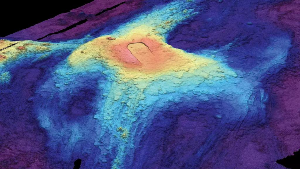 A 3-D bathymetric seafloor map of Axial Seamount in July 2014 shows lava flows from previous eruptions. Red indicates lava at the highest elevation above the seafloor, while dark blue at the edges shows where lava flow was thinnest