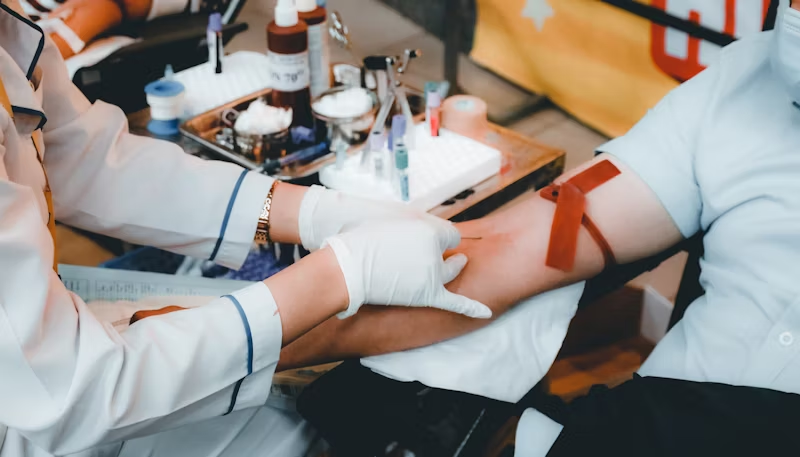 a doctor with multiple vials of blood from a human subject