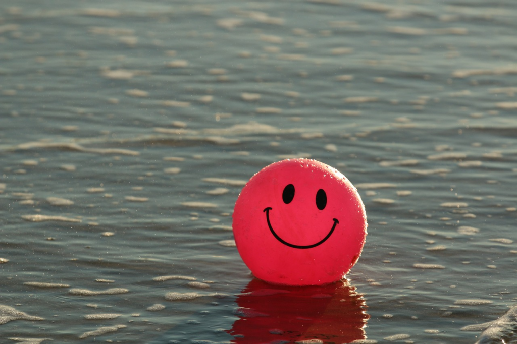 a smiling beach ball in water