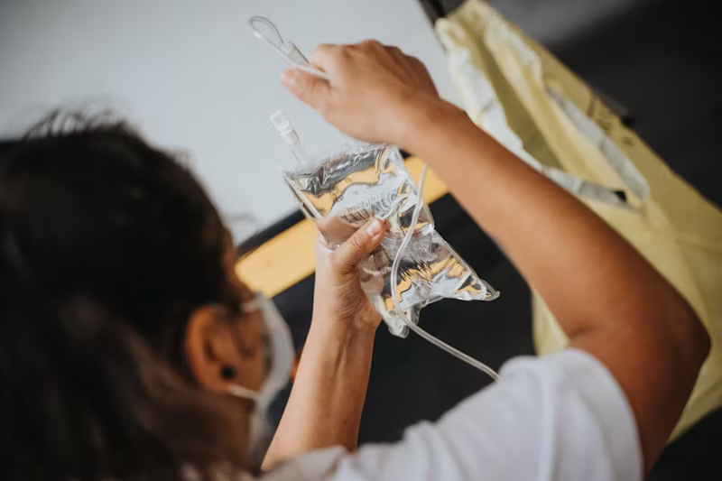 a person hanging up an IV