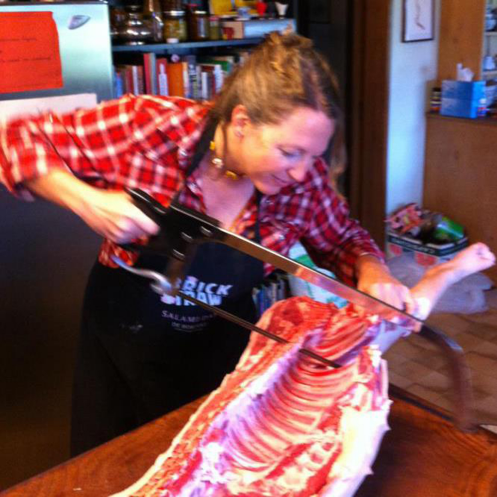 Tammi smiling and slicing meat