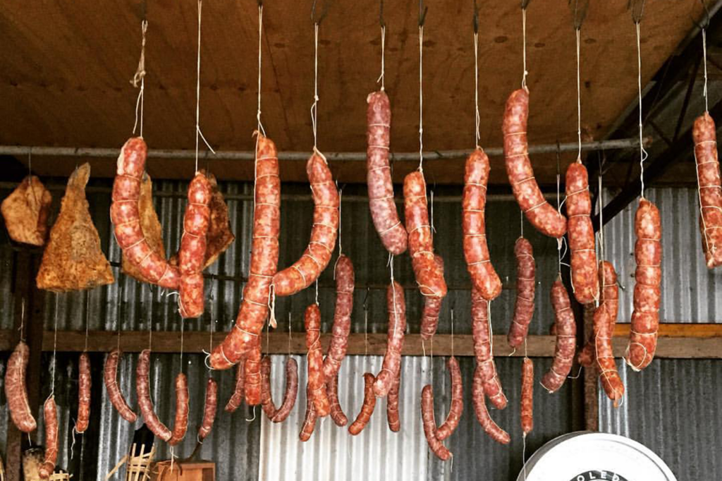Sausages drying in open air hanging from strings