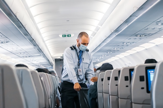 flight attendant collecting trash