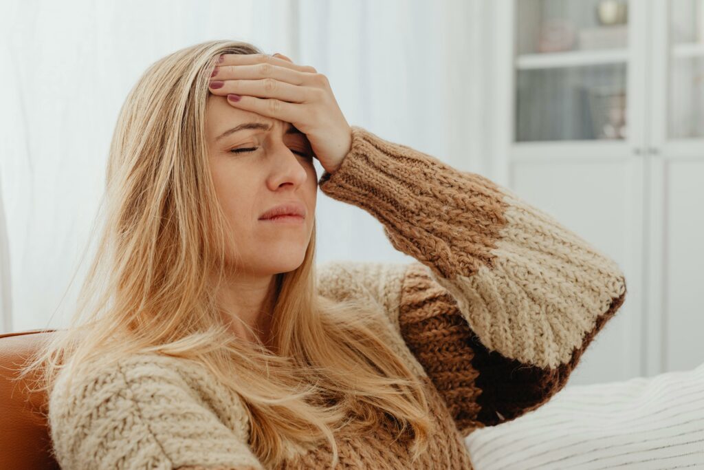 woman getting a headache out of stress 