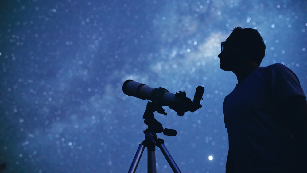 Astronomer with a telescope watching at the stars and Moon. My astronomy work.
