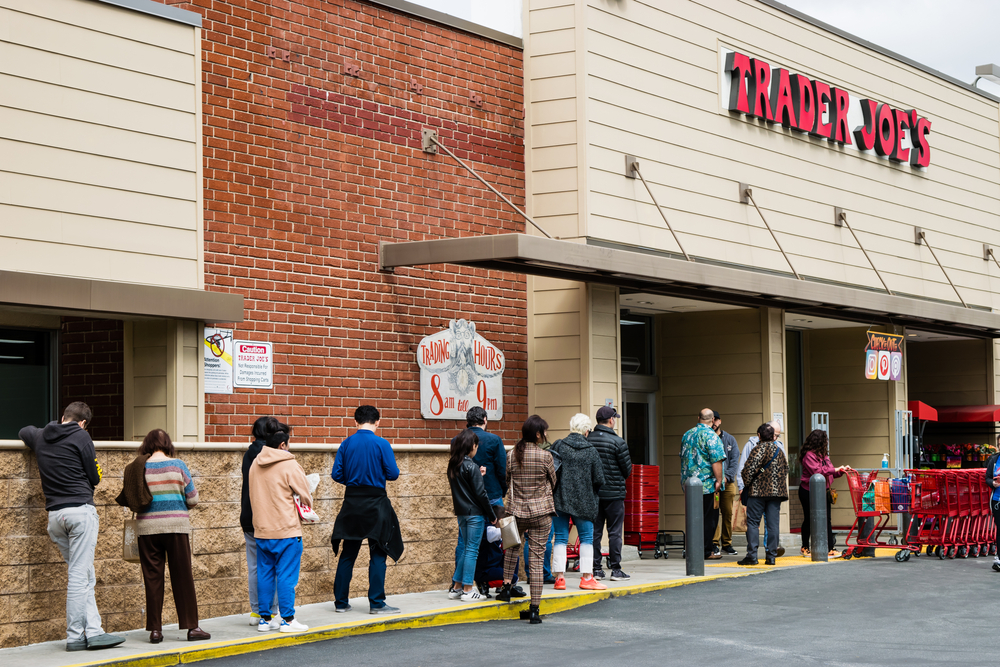 Glendale, CA/USA- March 15, 2020: Long line of COVID-19/coronavirus panic shoppers wait outside Trader Joe's grocery store