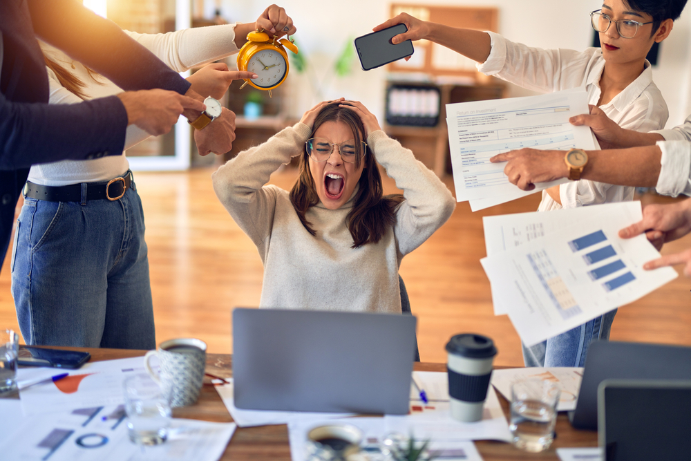 Group of business workers working together. Partners stressing one of them at the office