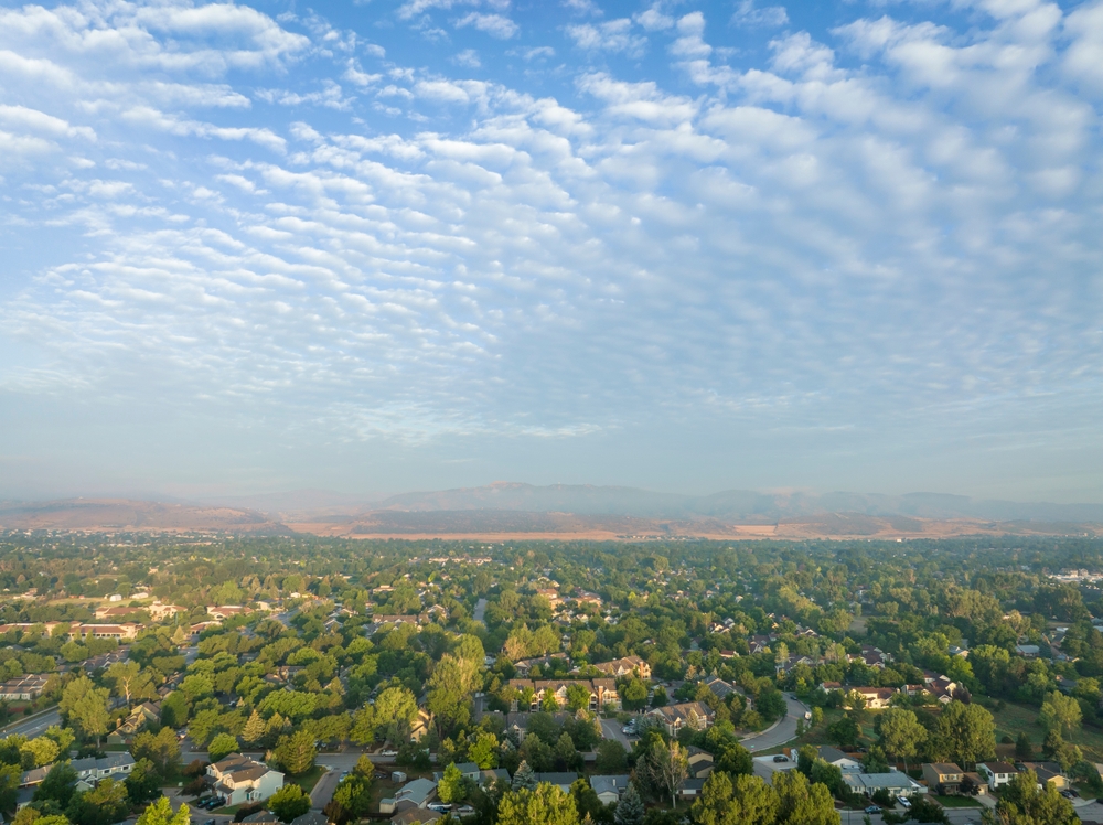 misty summer morning over Fort Collins and foothills of Rocky Mountains in northern Colorado, aerial view after heavy rainstorm with altocumulus clouds