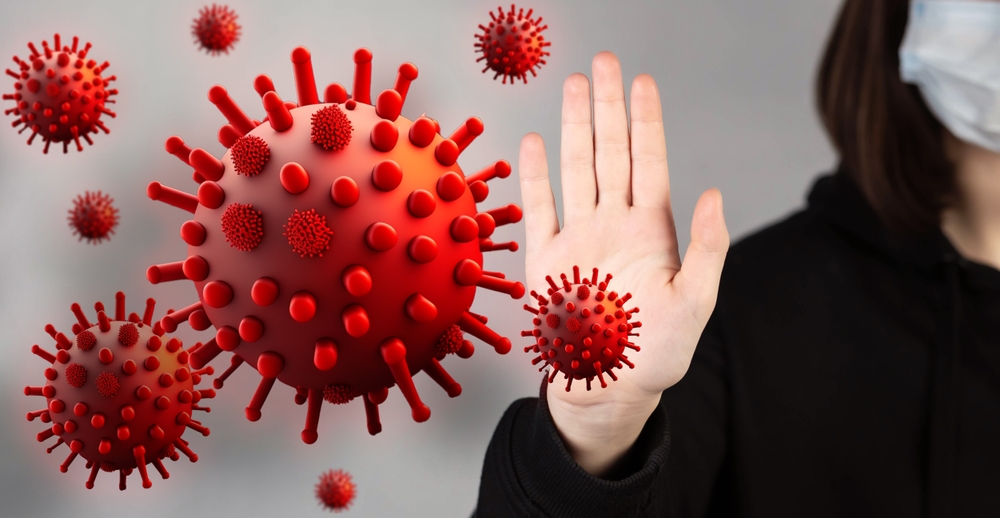 The girl is afraid of a flying virus, closes herself with her hands from a mutating virus.
