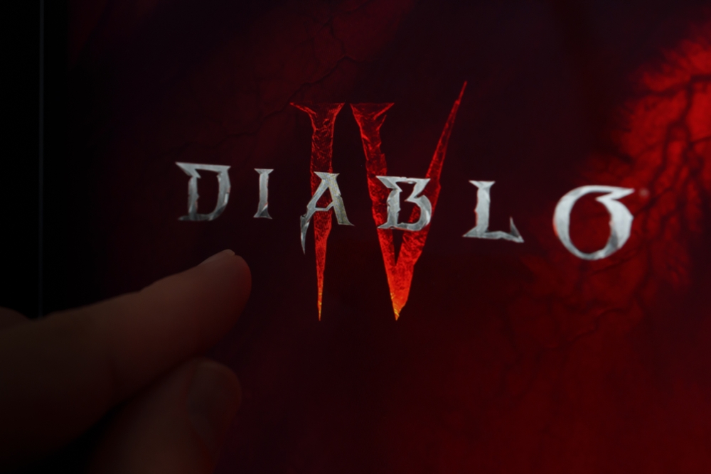 Diablo 4 game logo seen on the screen and finger pointing at it. Diablo IV is a game developed by Blizzard Entertainment. Stafford, United Kingdom, June 14, 2023
