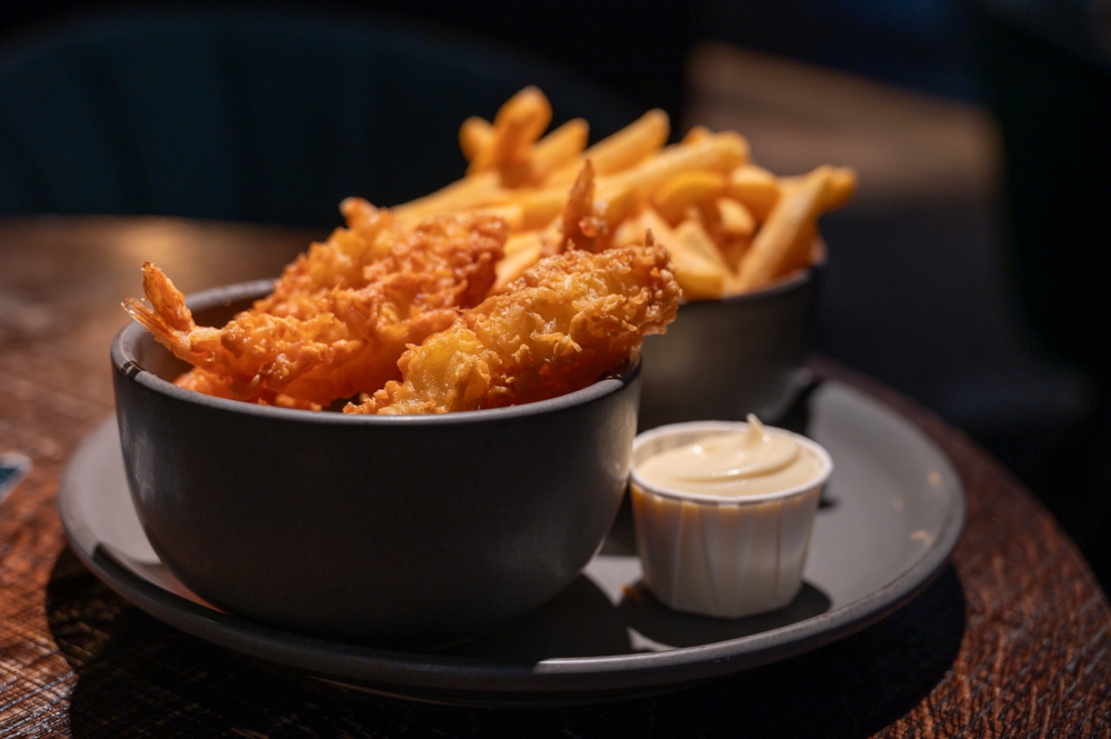 Dutch snacks for beer or wine, french fried potato chips and deep fried tempura shrimps and hot dip sauce and mayonnaise
