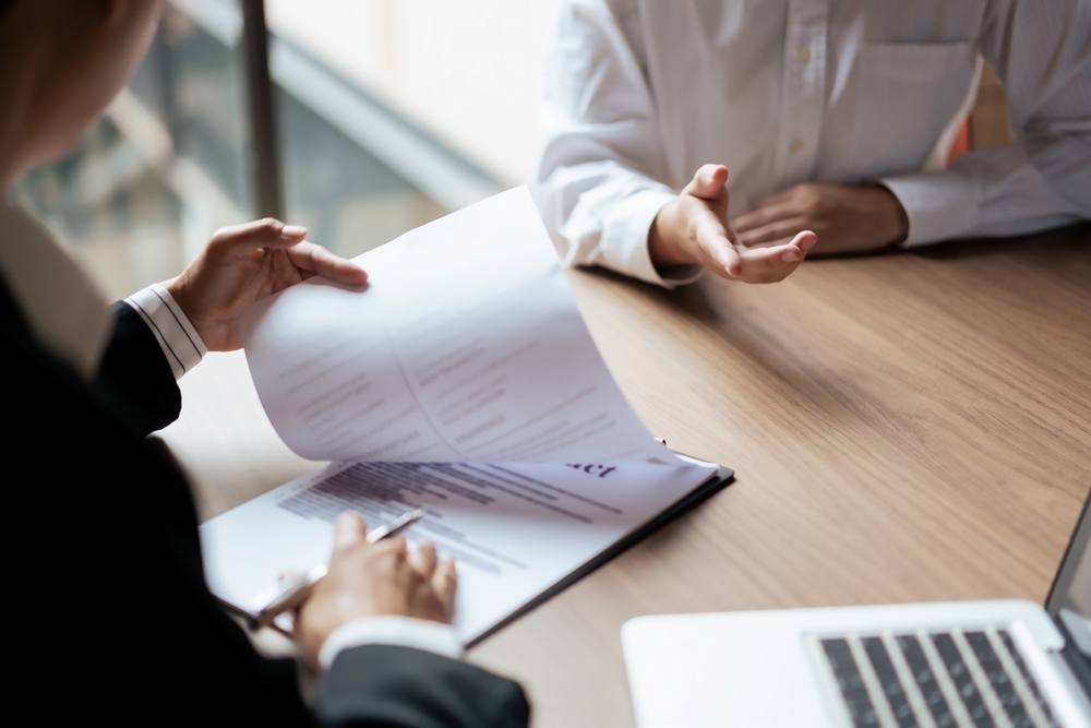 Male candidate job interviewing and answering question about cv and job experience with HR manager.