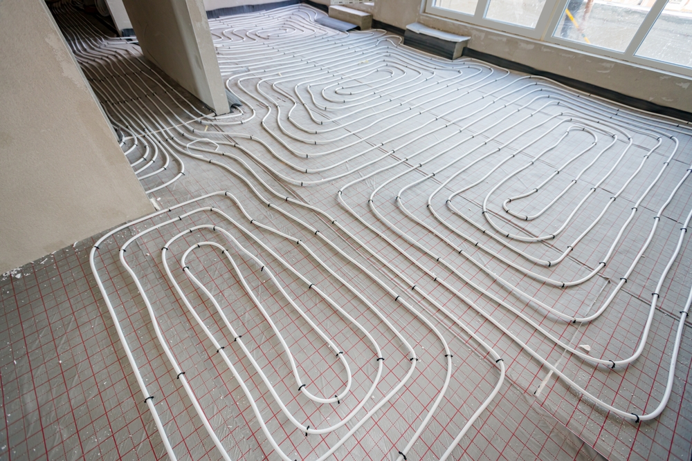 Pipe system of floor heating mounted in residential building under construction
