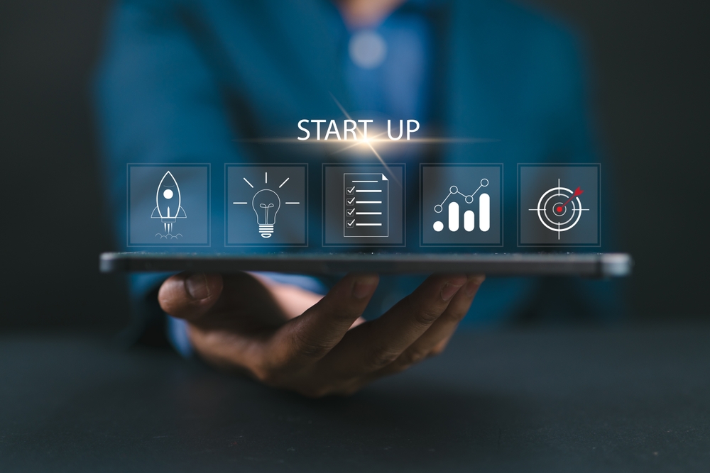 Startup business concept. Strategic planning and business success. Businessman use tablet with startup icon on virtual screen for starting a new business.

