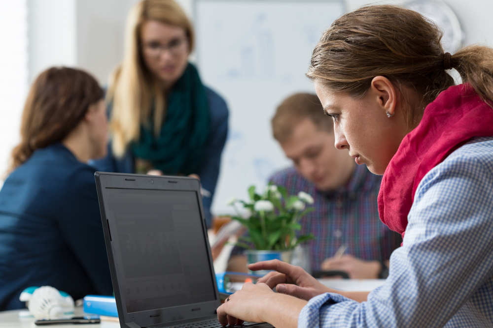 Woman working alone, isolating from business team