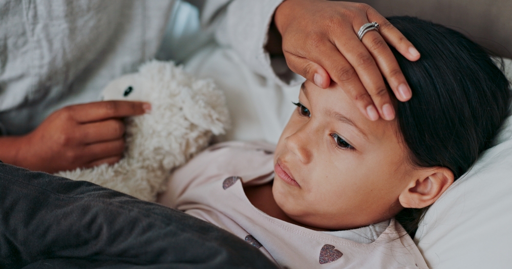 Flu, fever and mother with sick girl for health, virus or infection symptoms in bedroom. Family, childcare and hands of parent with child at home in bed to check temperature for cold, illness and flu