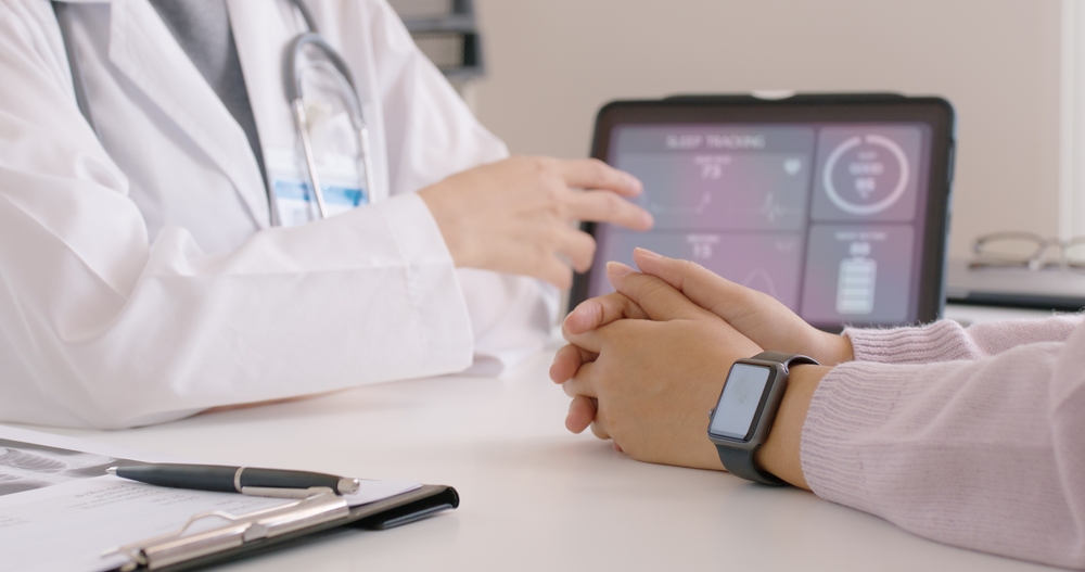 Close-up GP advice AI smart IoT watch guide to patient help collect ECG data, pulse heart rate, blood pressure, wrist sensor sport solution record connect to clinic health device digital platform app.
