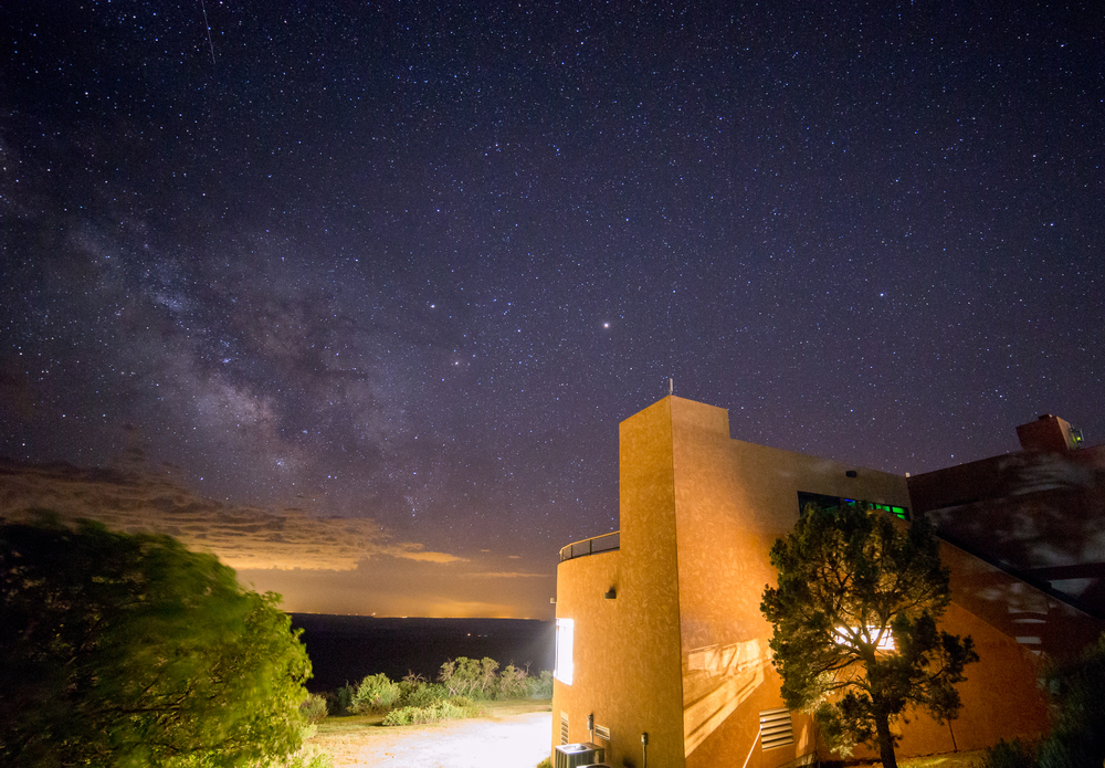 Dark night sky stars over Mesa Verde National Park lodge.
