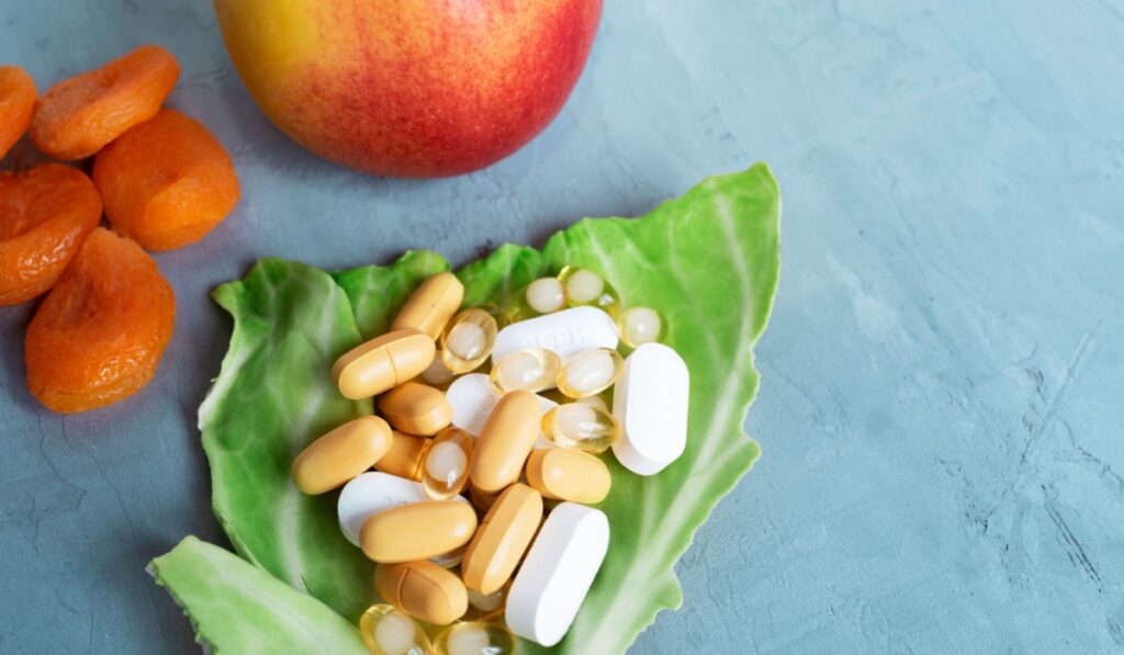 Pills, vitamins for pregnant women, food supplements on a gray-blue background