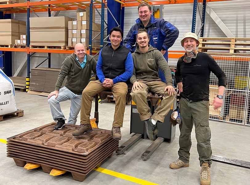 CocoPallet team members with some pallets in a warehouse