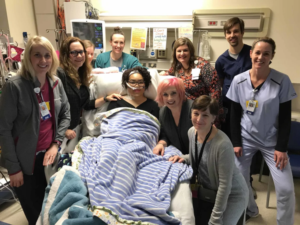 Zei Uwadia, center, with her mother and medical team at Children's Mercy Kansas City. Clockwise from left: Kari Davidson, Dr. Jenna Miller, Ryanne Toland, Julie Pearson, Debbie Newton, Dr. Jay Rilinger, Jill Dinkel, Dr. Marita Thompson and Zei's mother, Brie Kerschen.