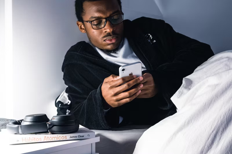 man on his phone in bed